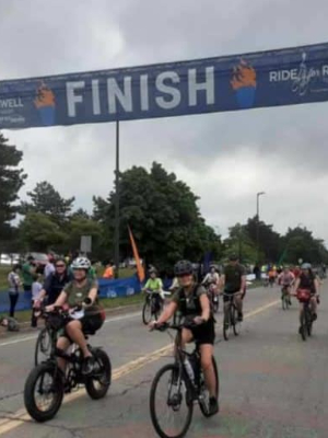 At 30-mile ride finish line in 2023 with Combat Cancer team!